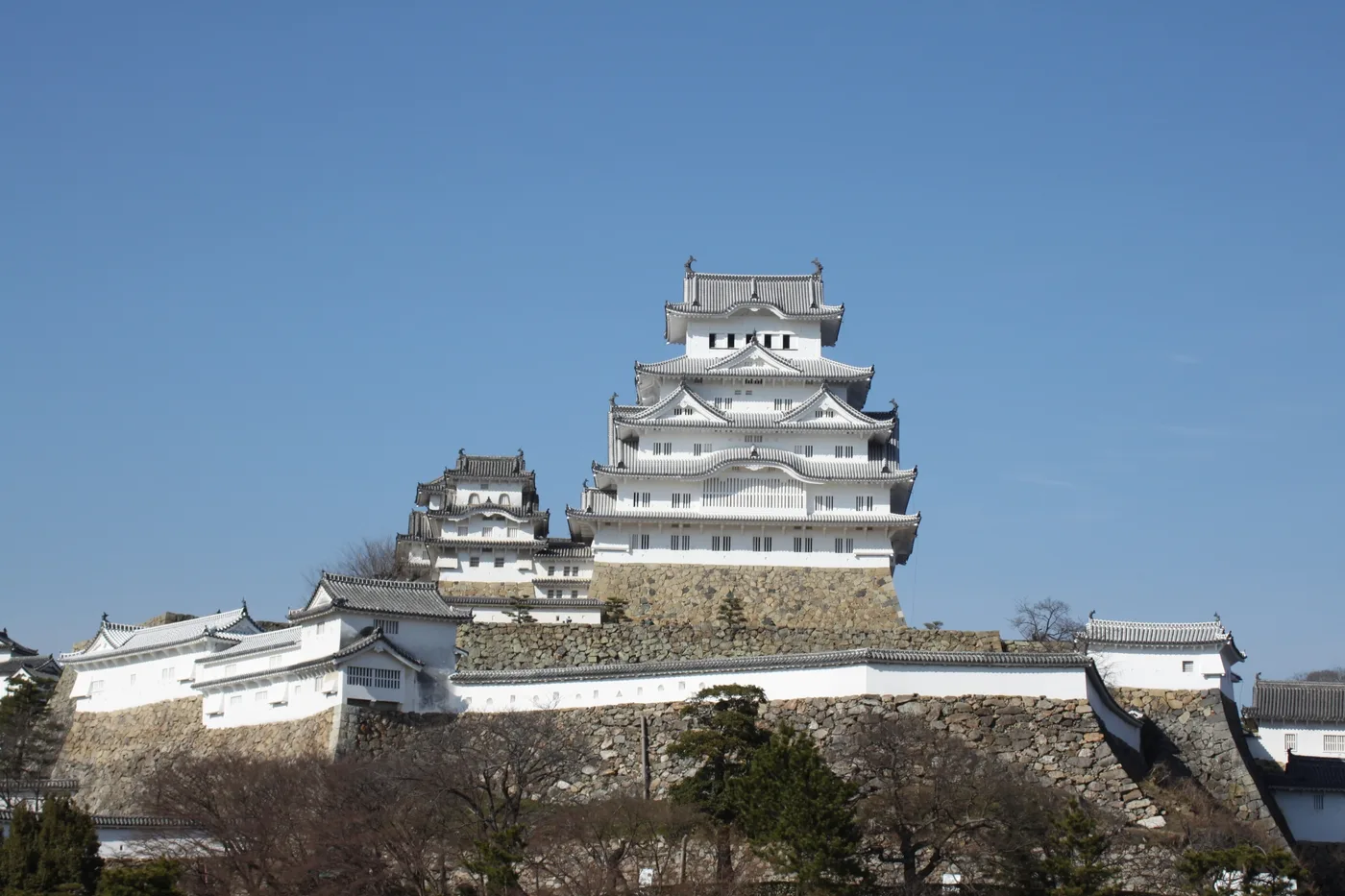 The white main keep of Himeji Castle beneath a clear blue sky