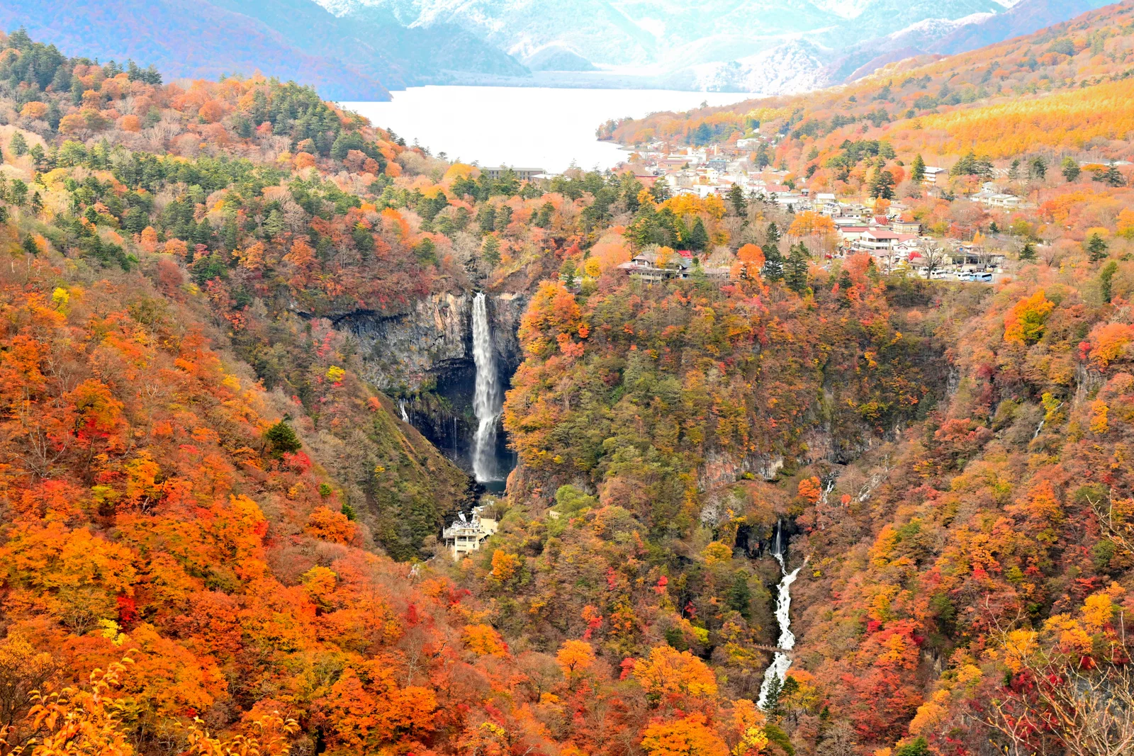 Kegon Falls surrounded by orange autumn forest in Oku-Nikko
