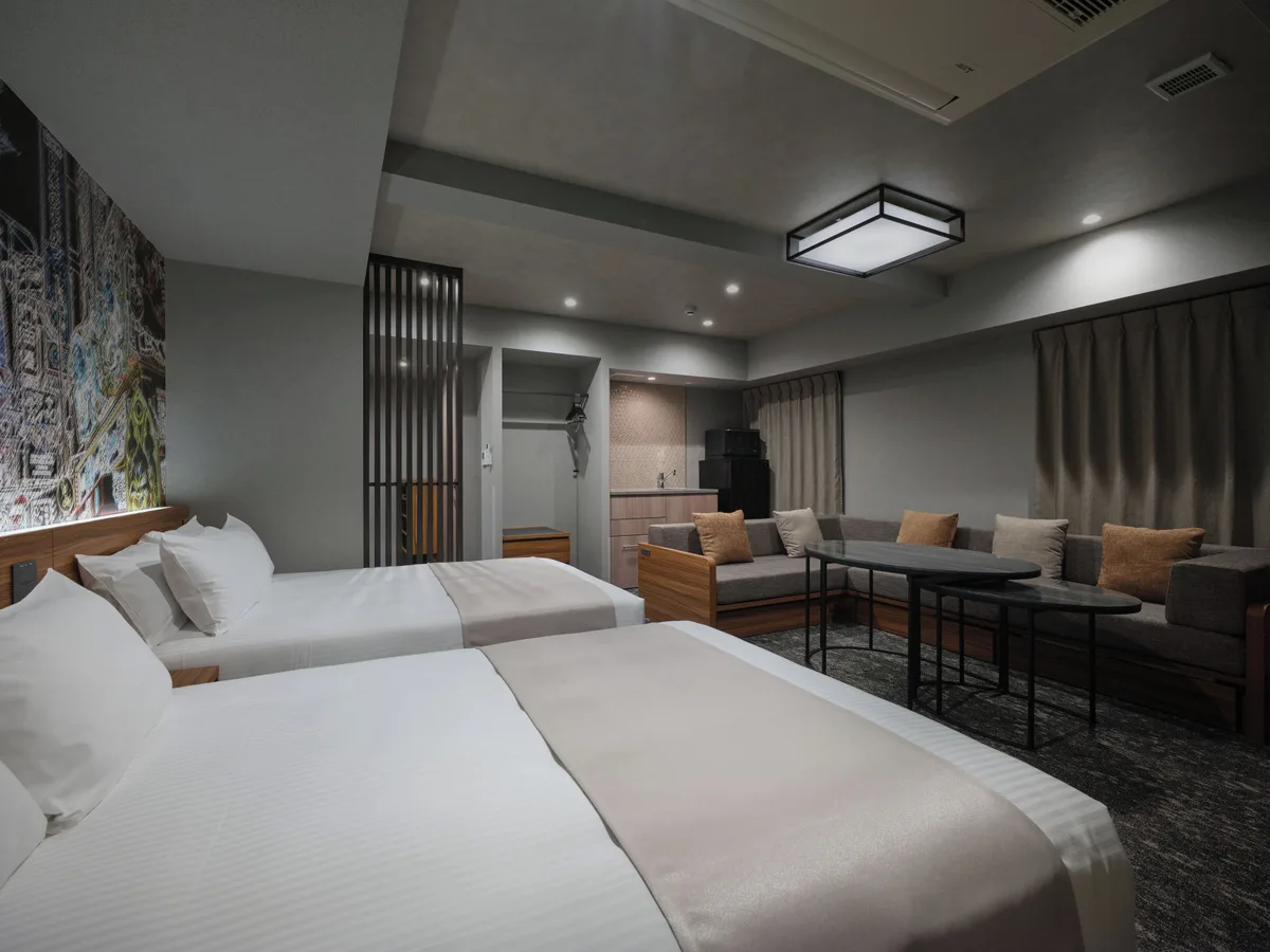 Beds, seating and a dining area at MONday Apart Premium OSAKA NAMBA WEST