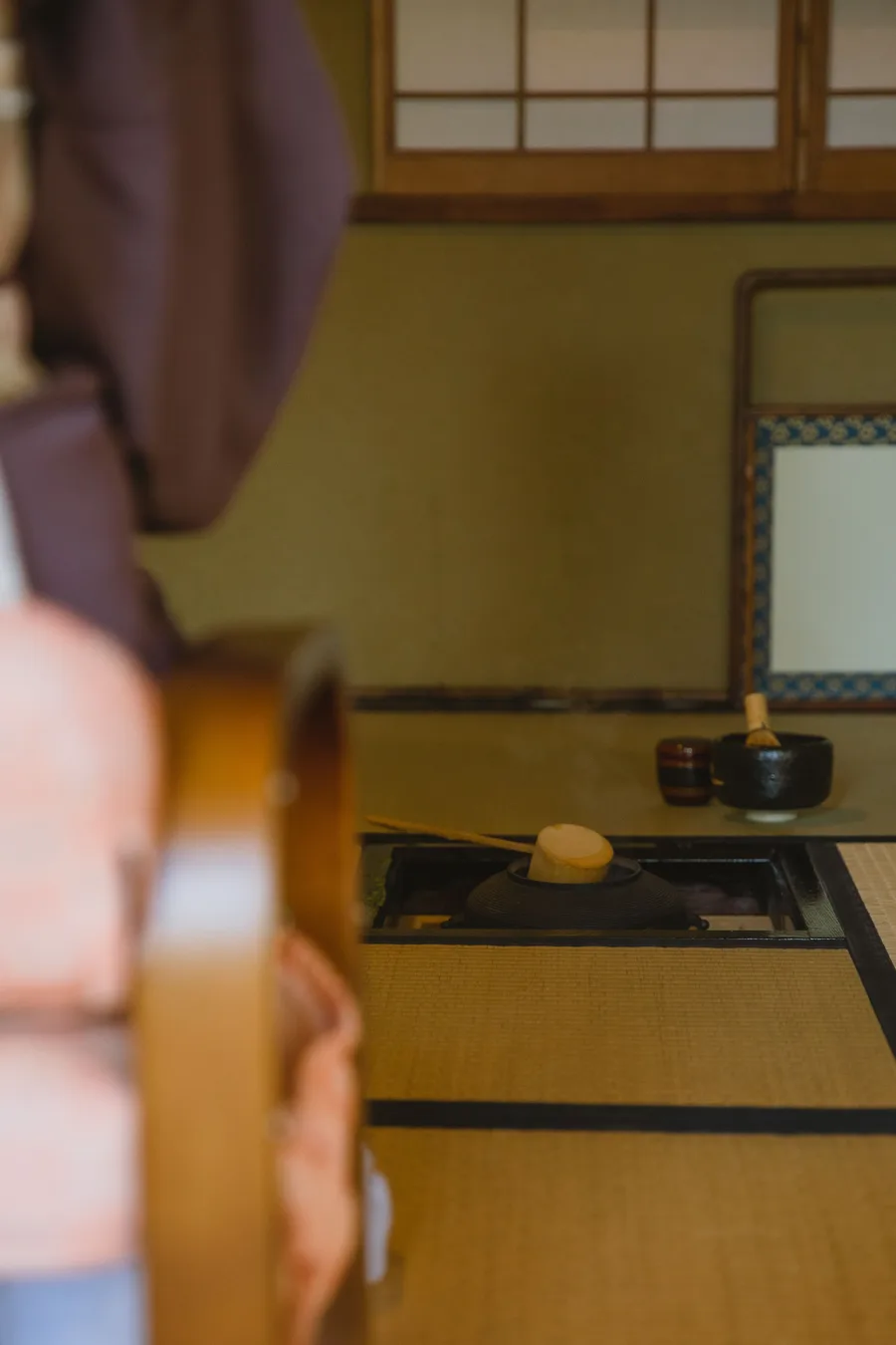 Tea utensils arranged beside a sunken hearth in a Kyoto tatami room