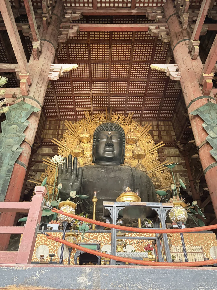 The bronze Great Buddha inside Todai-ji, surrounded by a golden halo and tall wooden columns