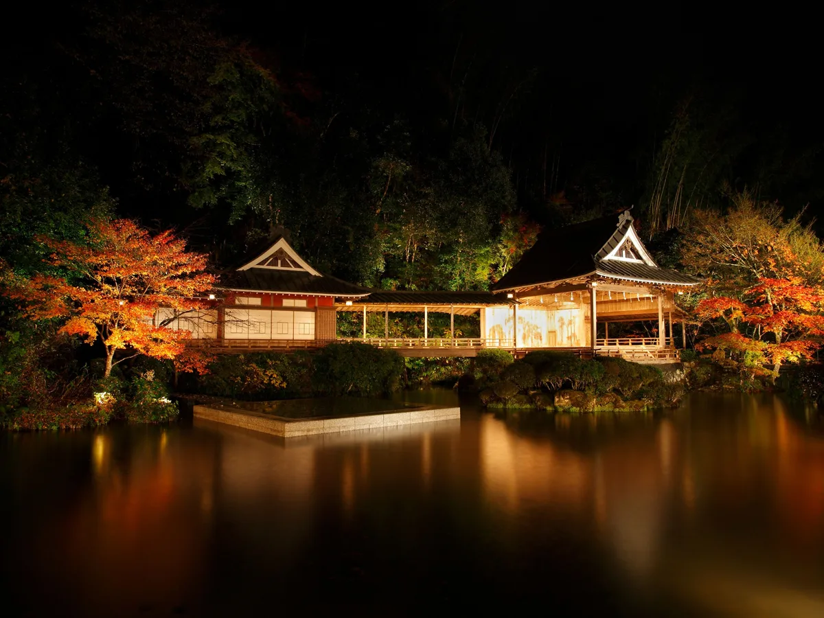 Illuminated Noh stage and autumn foliage reflected in the pond at Asaba