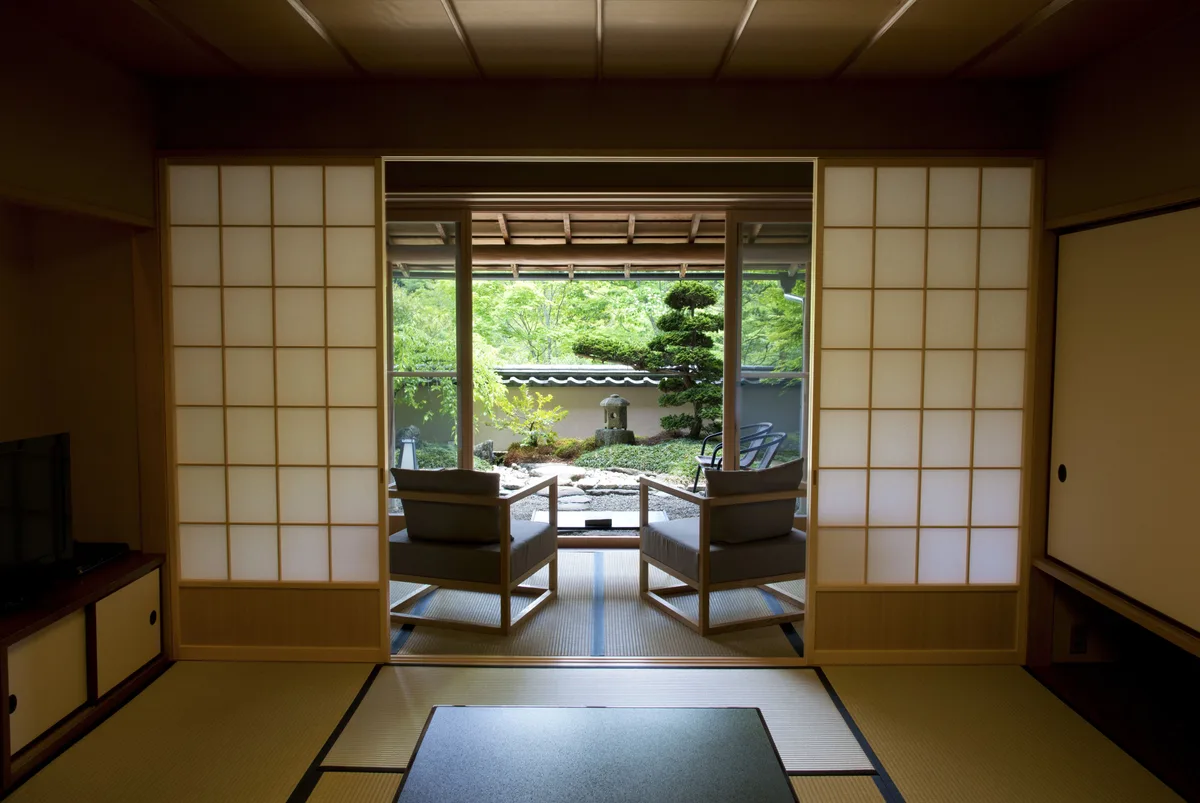 Tatami room opening onto a garden-facing sitting area at Gora Kadan