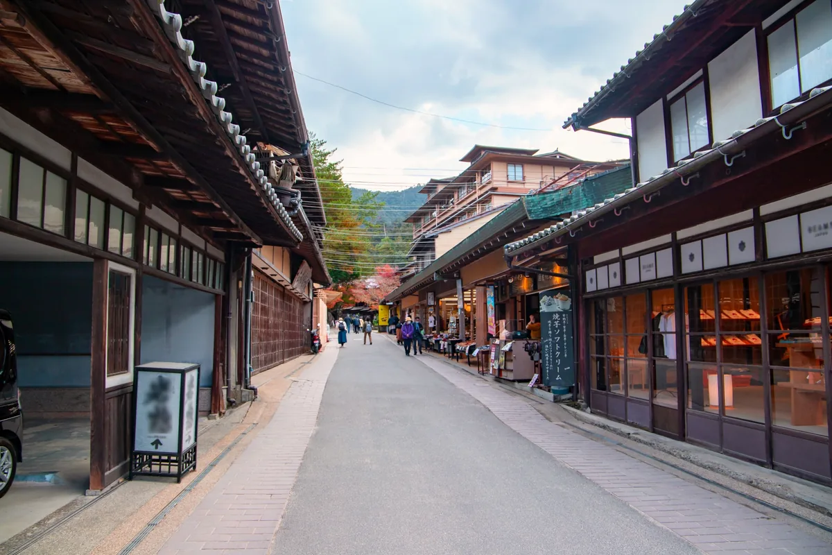 A narrow Miyajima street lined with traditional wooden shopfronts
