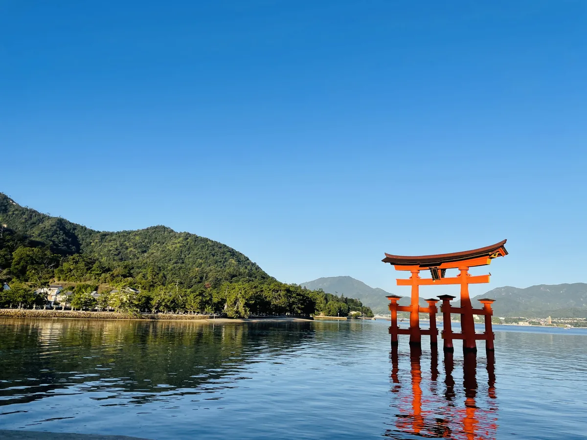 Miyajima's torii standing in the water with its reflection beneath it