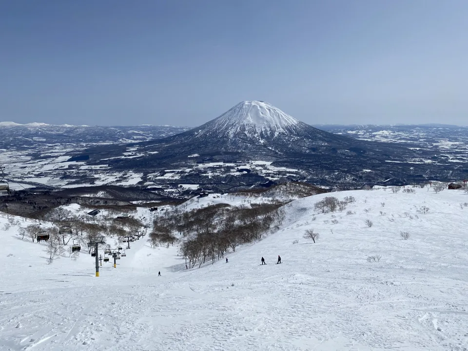 Ski slopes and chairlifts at Hirafu facing snow-covered Mount Yotei
