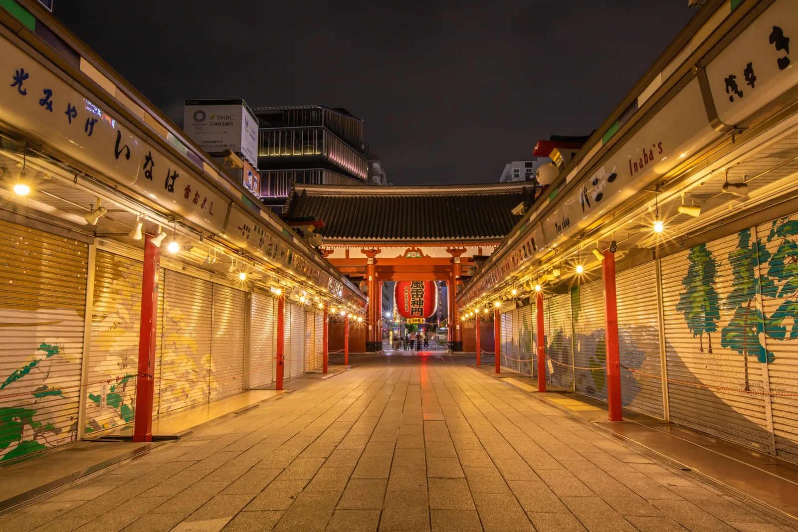 Closed Nakamise shops glowing beneath warm lights at night