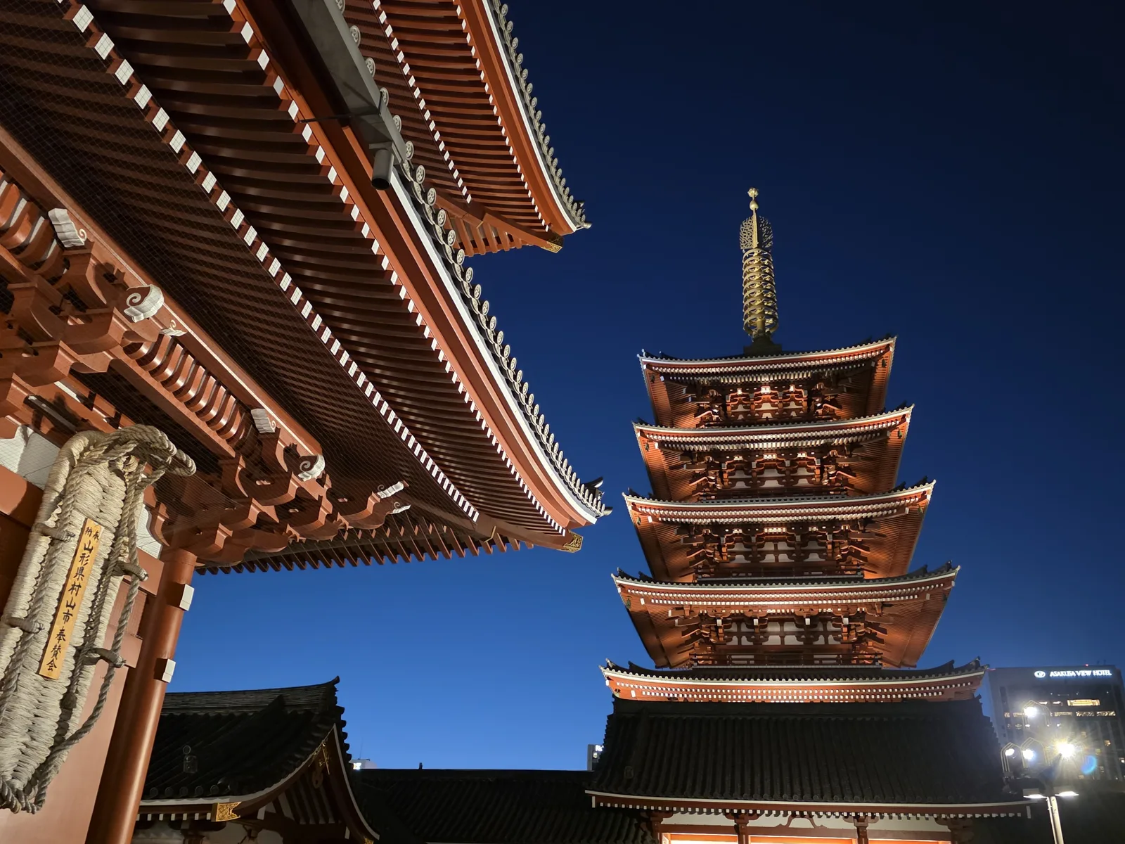Sensoji five-story pagoda and temple roof illuminated at night