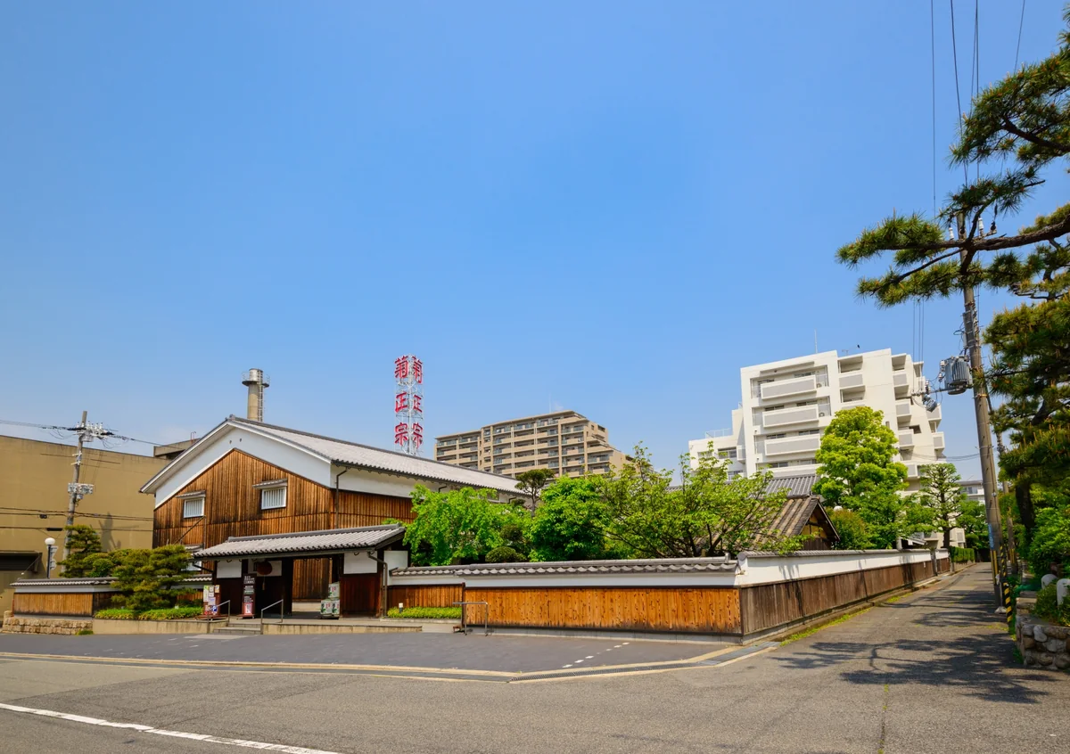 Kikumasamune Sake Museum's wooden frontage, tiled roofs and red brewery sign in Kobe