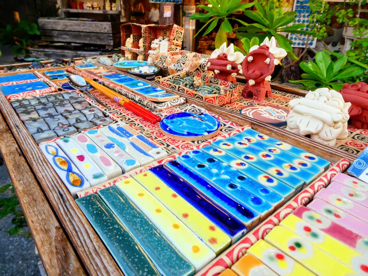 Colorful ceramic chopstick rests, small dishes and shisa figures on display