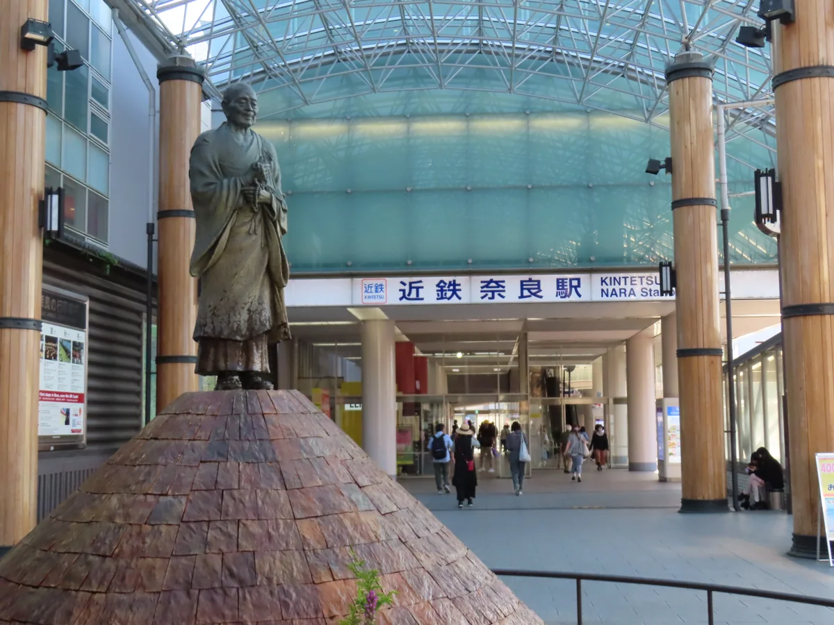 The entrance area of Kintetsu-Nara Station with a statue in front