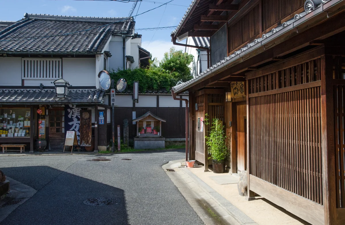 Wooden latticework and traditional buildings around a street corner in Naramachi