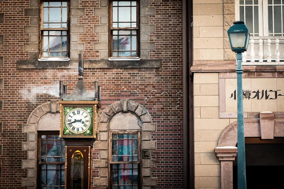 The clock beside the brick facade of Otaru Music Box Museum