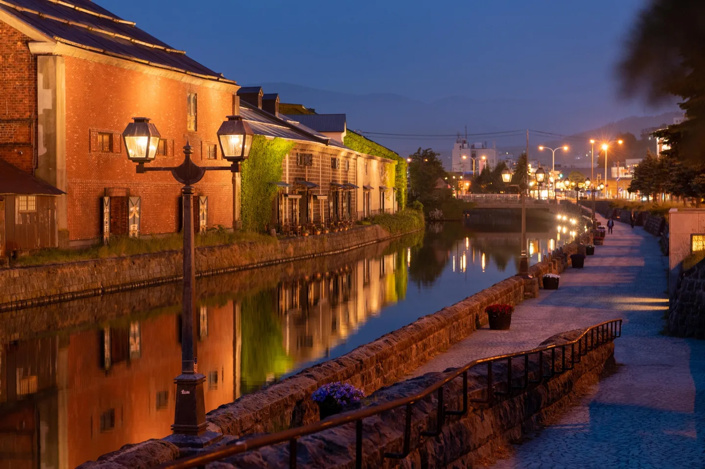 Gas lamps and warehouses reflected in Otaru Canal after dark