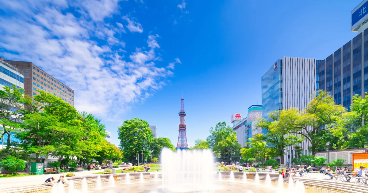 A fountain in Odori Park with Sapporo TV Tower in the background