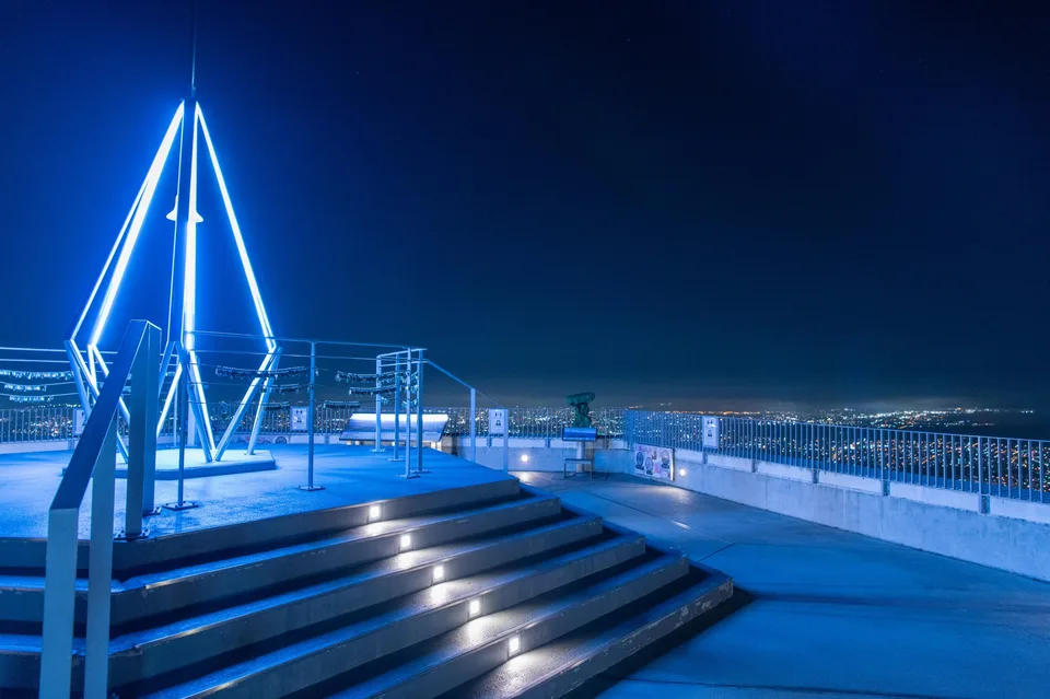 An illuminated installation on the Mount Moiwa observation deck at night