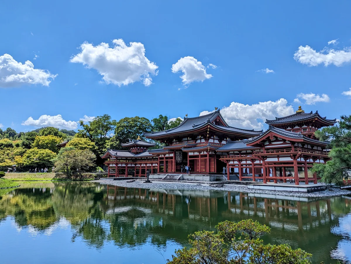 Byodoin Phoenix Hall reflected in the pond, with its side corridors and garden visible