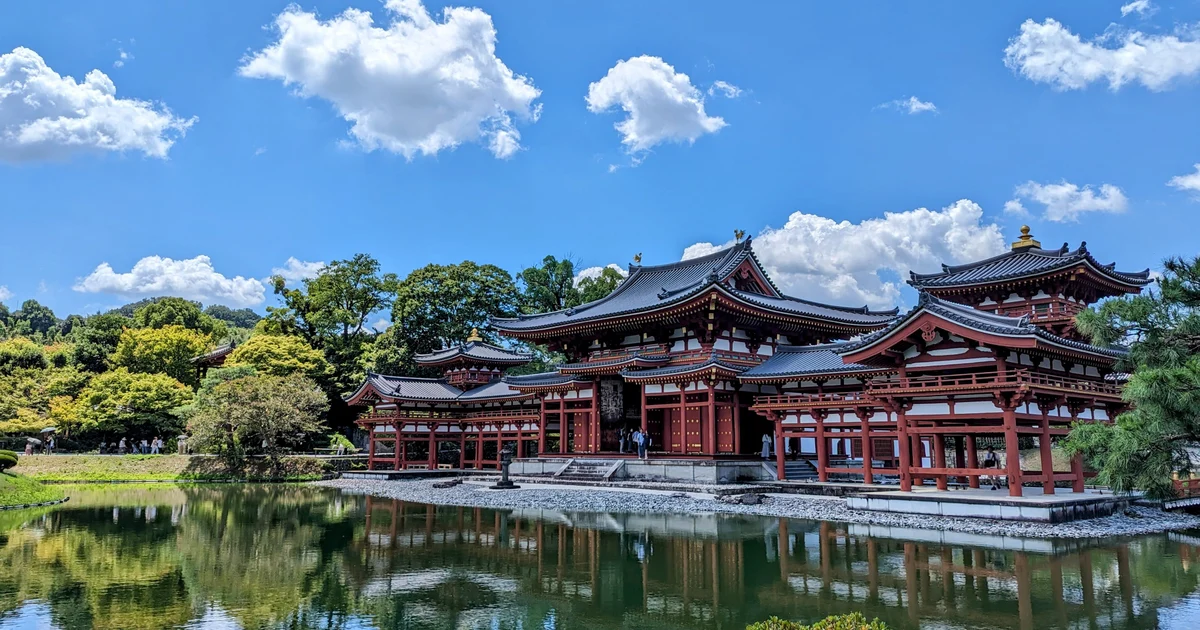 Byodoin's Phoenix Hall and its reflection in the pond beneath a blue summer sky