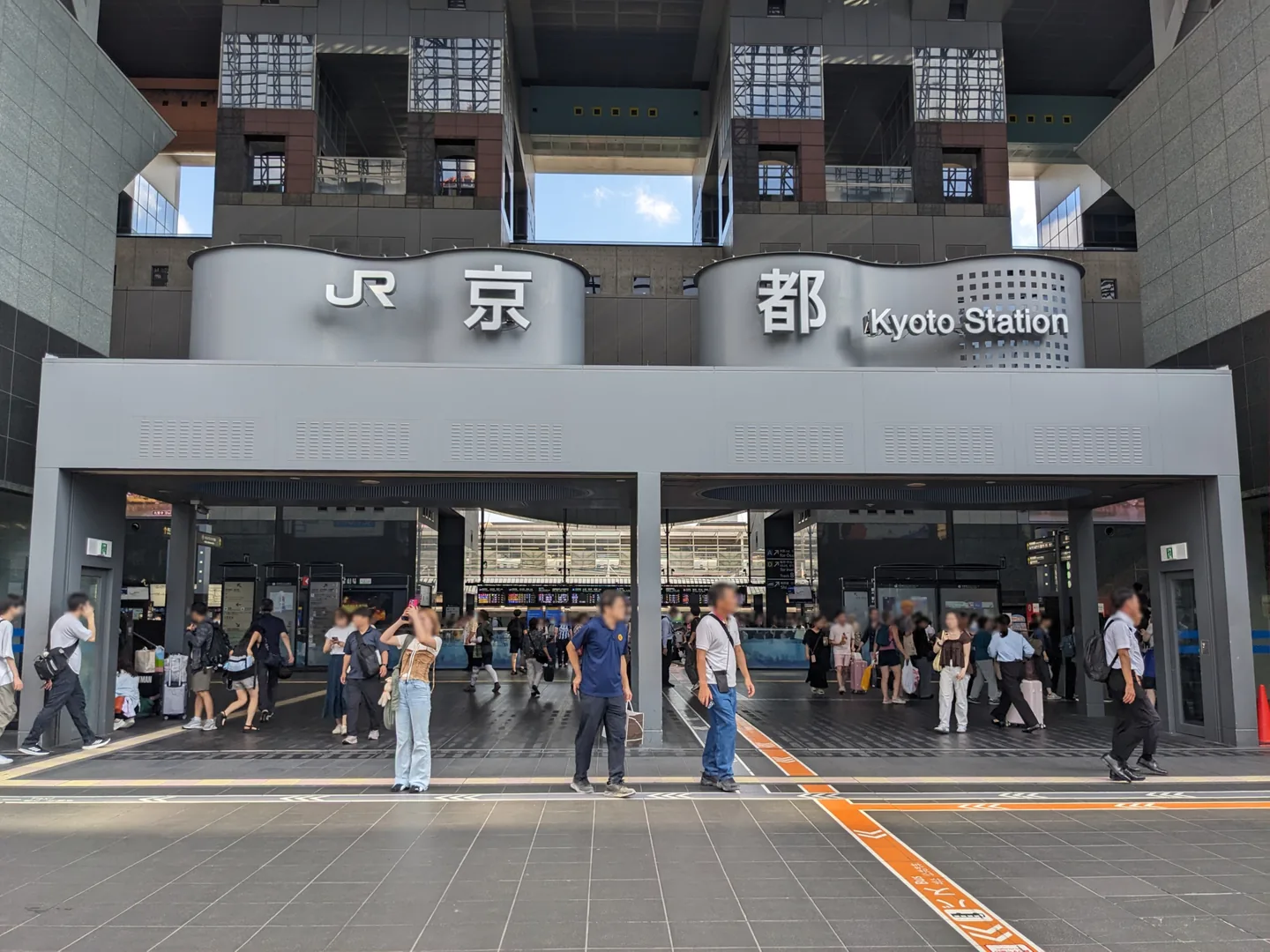 The central entrance of JR Kyoto Station with Japanese and English station signs